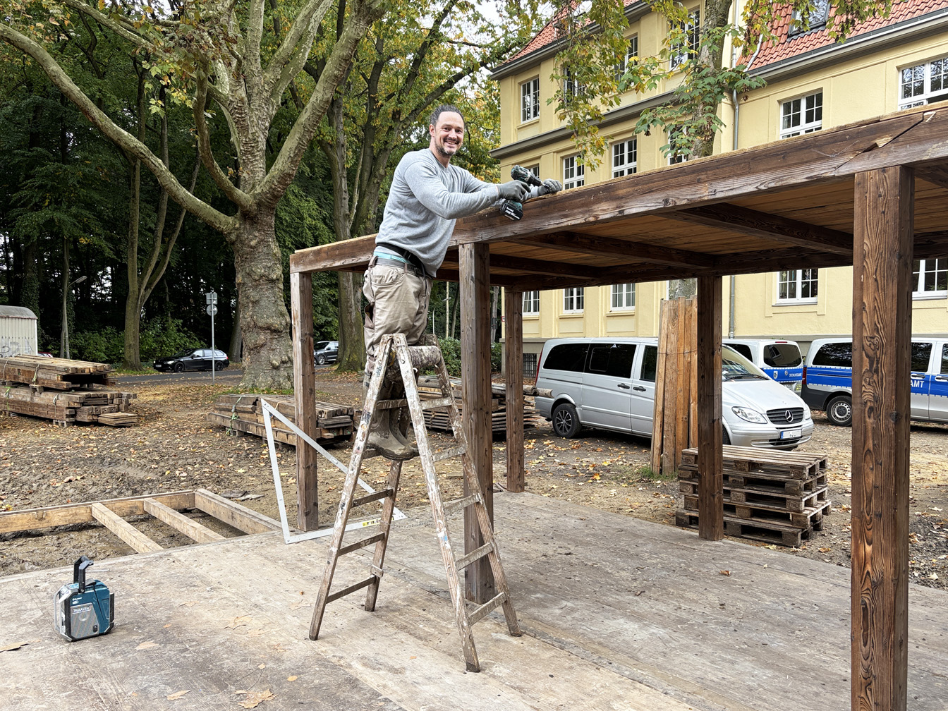 Veranstalter Max Schmitz hilft selbst beim Aufbau des Weihnachtsdorfs am Rathaus mit.