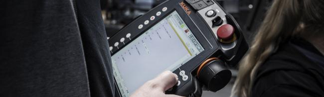 Das Bild zeigt eine Person, die ein Handheld bedient.