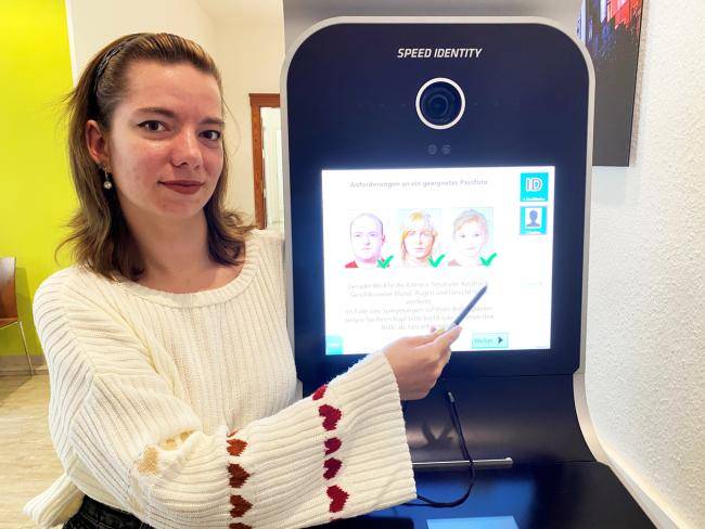 Lea Bazan - Mitarbeiterin im Bürgerbüro - zeigt den Bildautomaten Speed Indentity